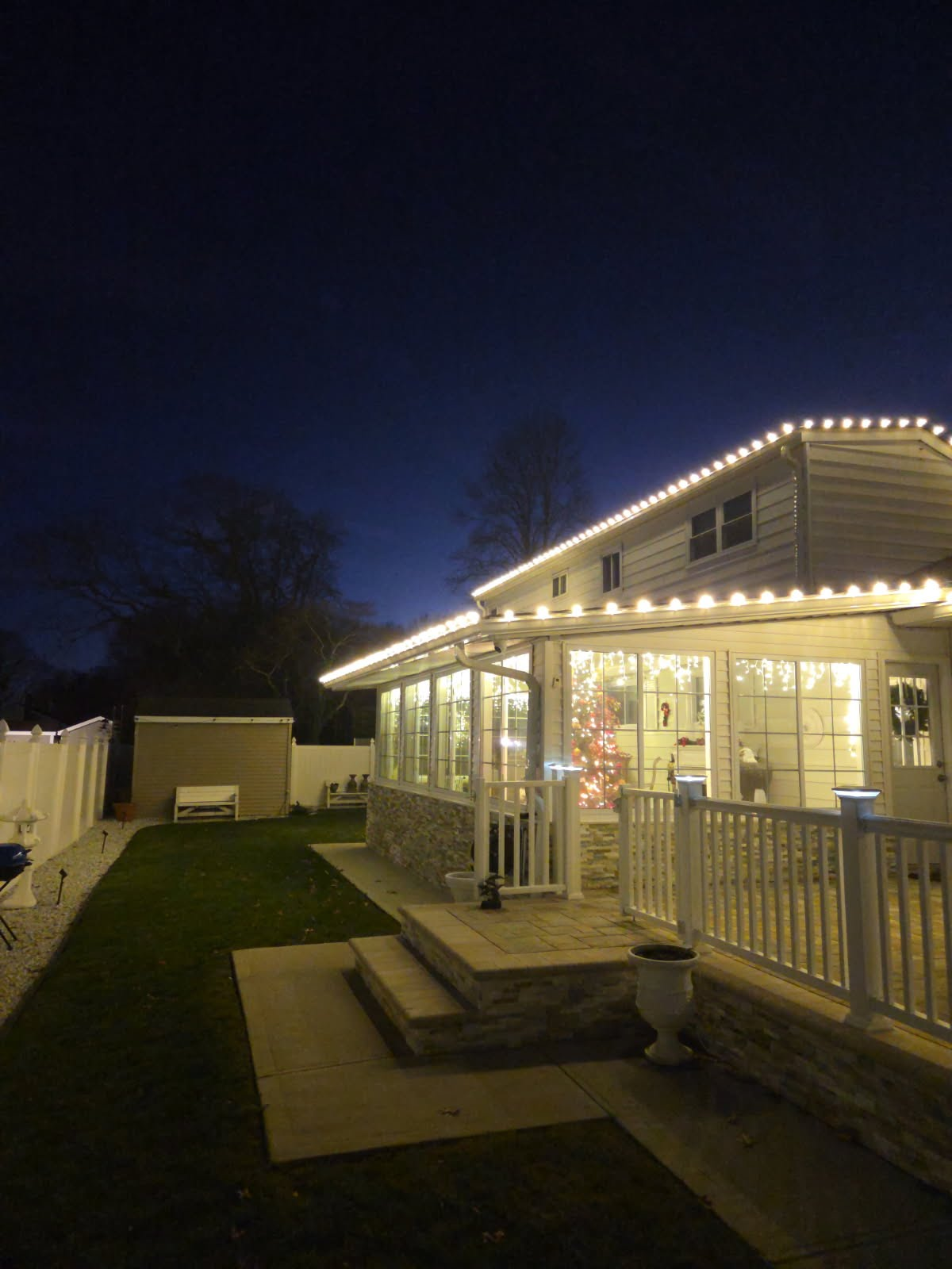 Finished warm white Christmas light installation on a Suffolk County home