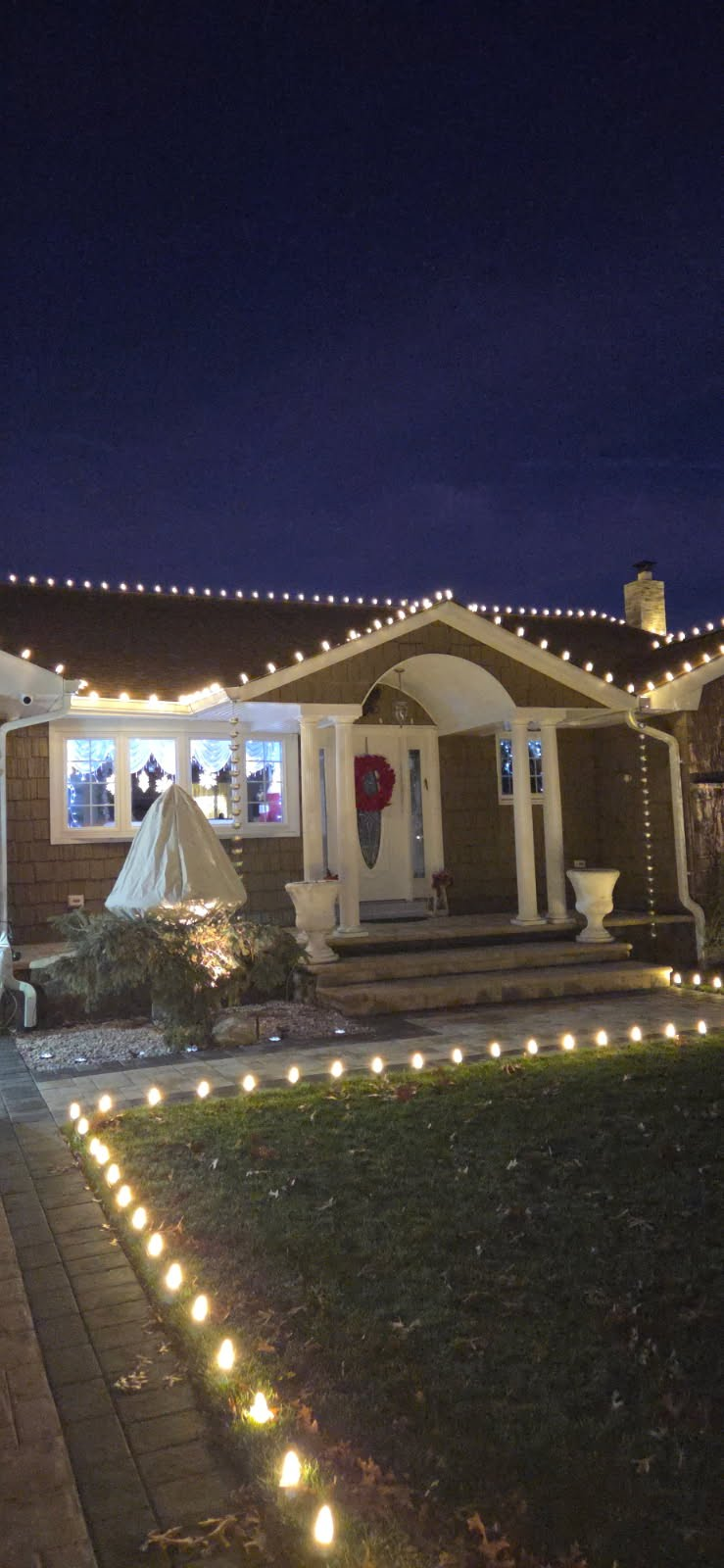 Christmas lights installed along a home walkway and entrance