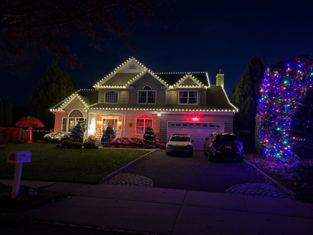 Warm white Christmas lights installed along roof peaks and gutters